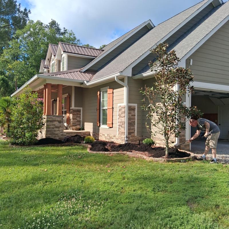 Refurbished flower beds by removing red mulch and replacing it with black mulch in Florence, MS
