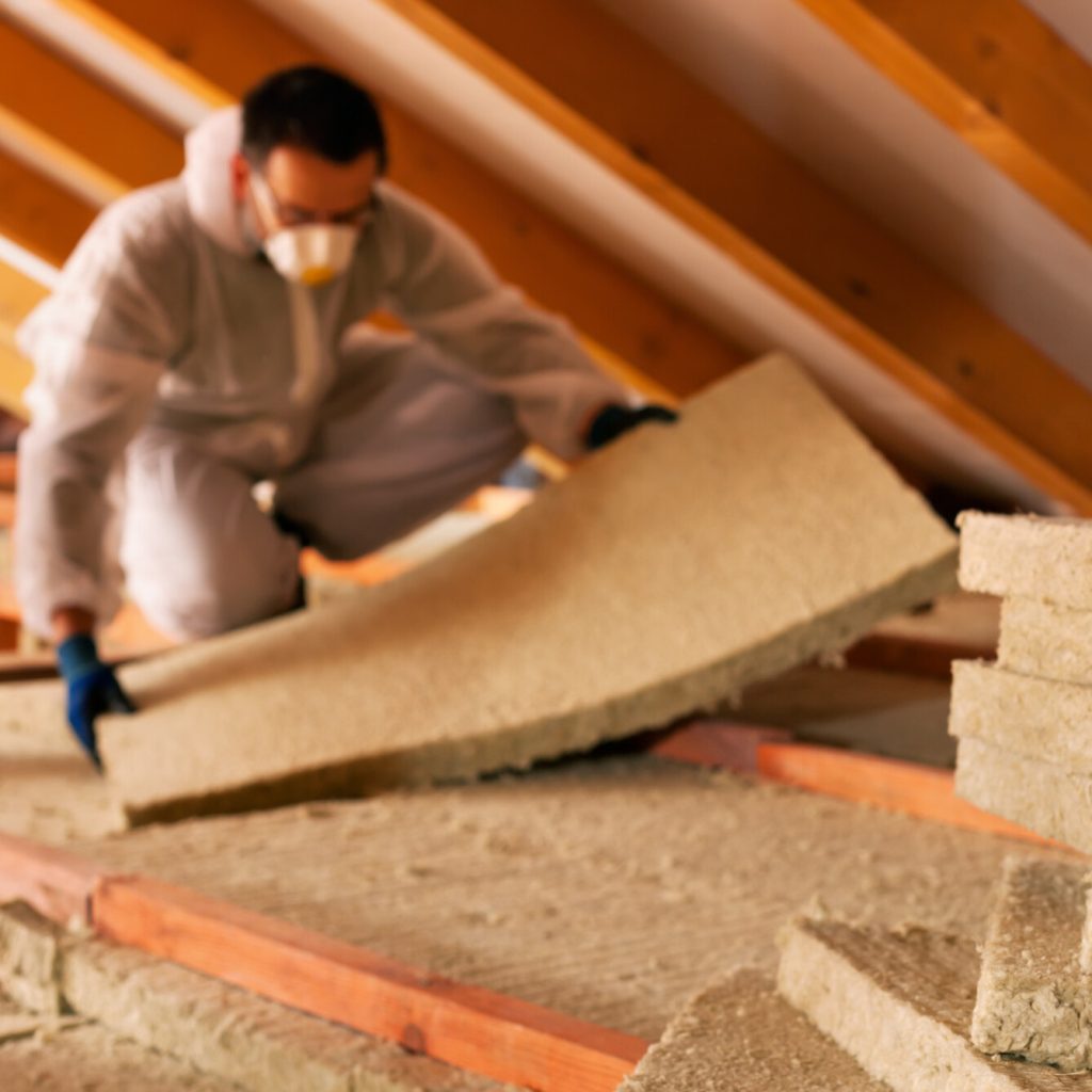 Contractor installs insulation.