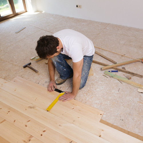 Contractor installs flooring.